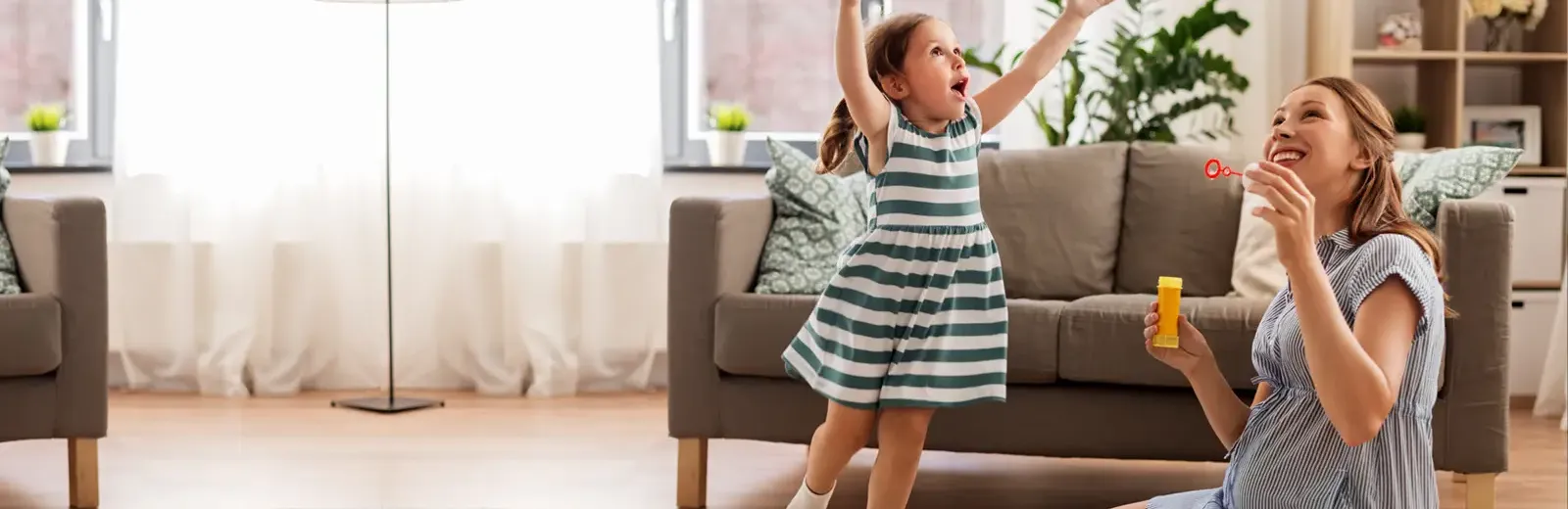 Family blowing bubbles in living room